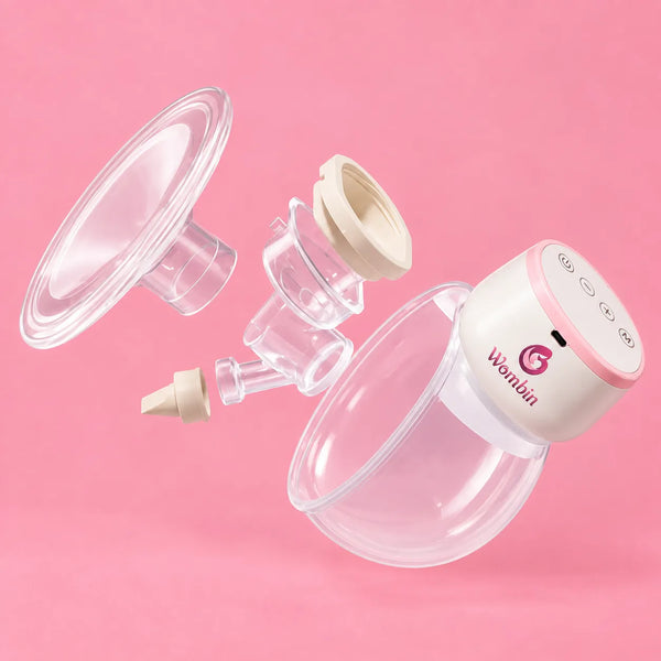 A breast pump and collection system set against a solid pink background, featuring a white and pink motor unit with the brand name 'Wonda' printed on it, alongside clear silicone flange, breast pump head, and collection tube with a beige cap.
